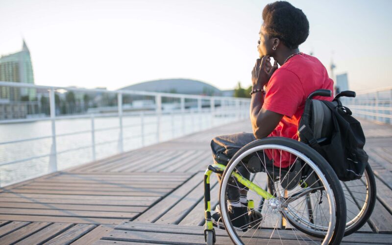 man in wheelchair on bridge