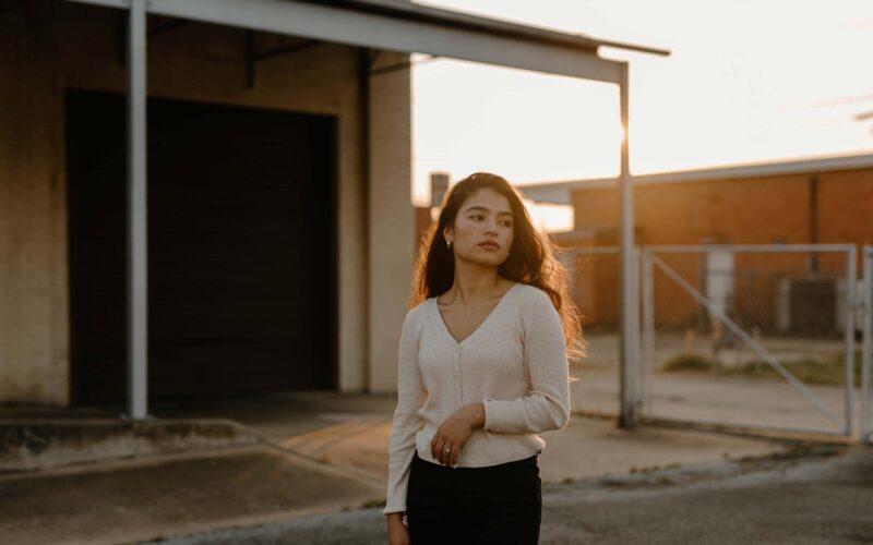 woman in front of old building during sunset